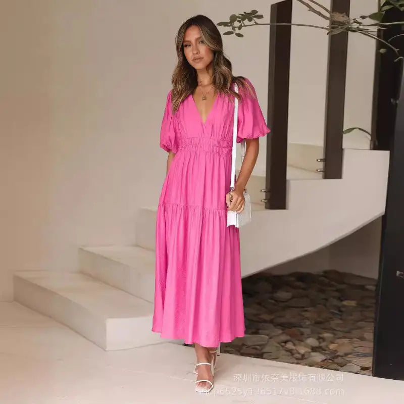 Woman in a pink tiered maxi dress.