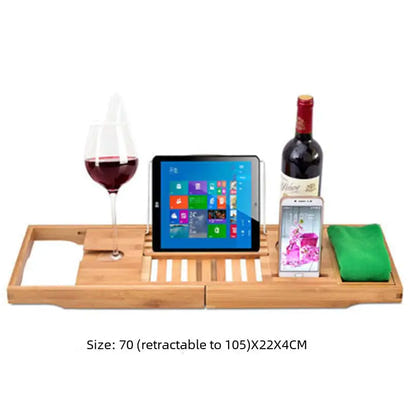 Bamboo bathtub caddy with wine glass, tablet, wine bottle, phone, and towel.