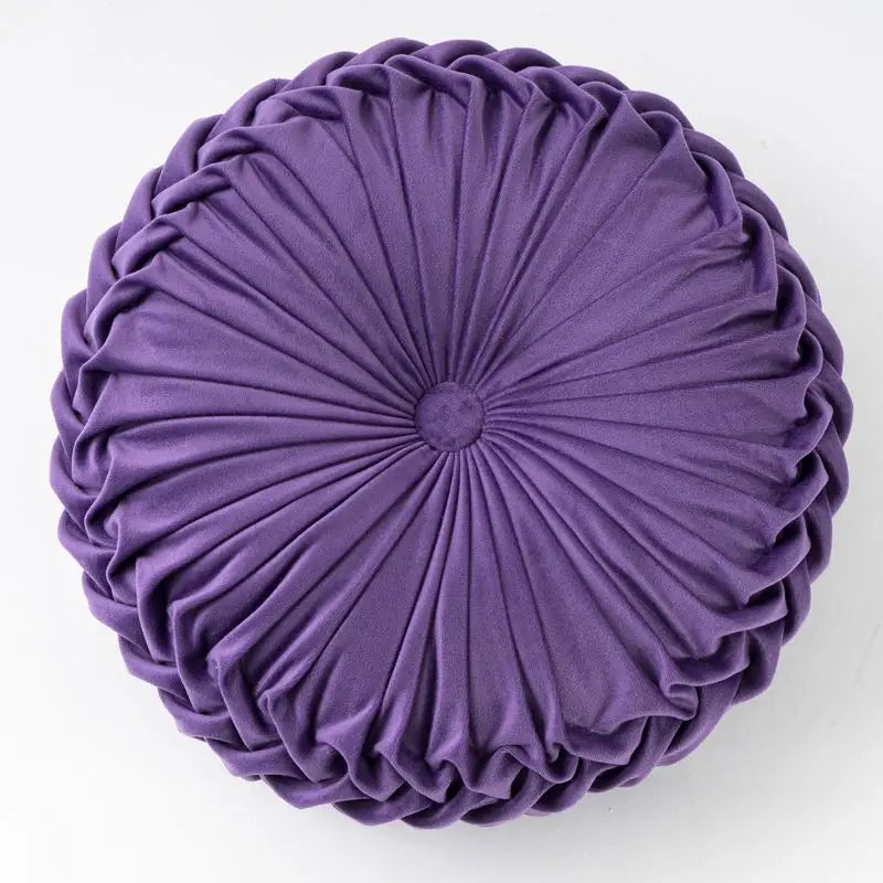 Round purple pleated pillow designed as a playful pumpkin pillow with a unique pumpkin shape