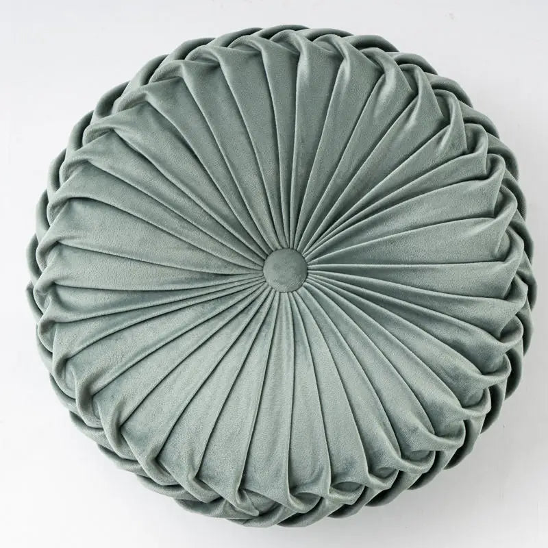 Round pleated velvet pillow in a playful pumpkin shape for cozy decor