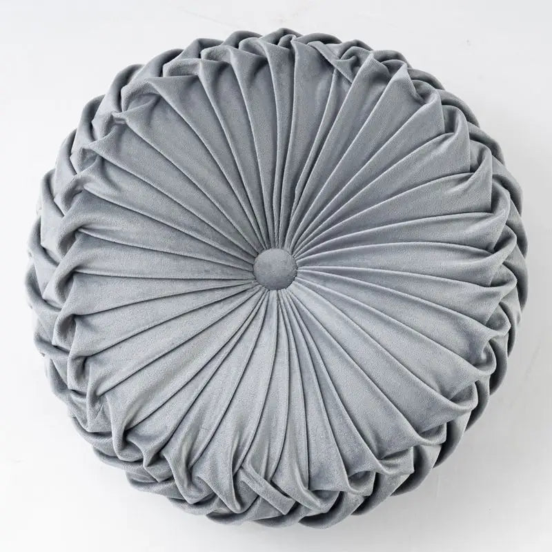 Round gray pleated pillow with playful pumpkin pillow and unique pumpkin shape design