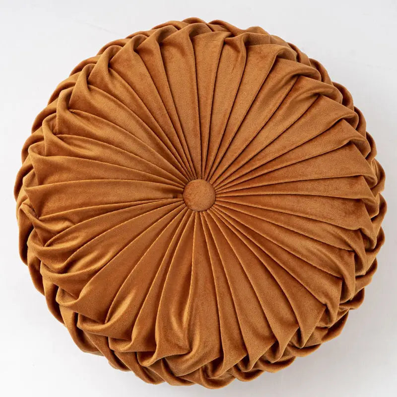 Round pleated golden-brown velvet pumpkin pillow with a playful pumpkin shape