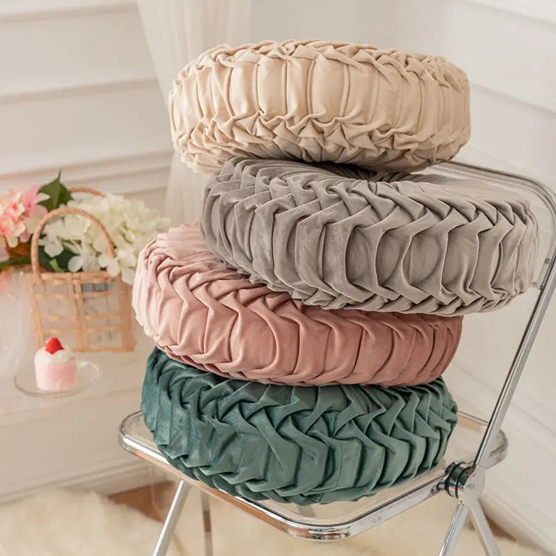 Stacked round pleated pillows from the playful pumpkin pillow Wheel Cushion in a unique pumpkin shape