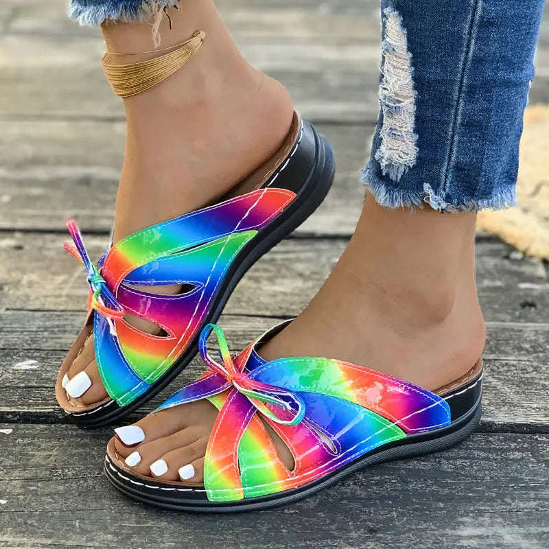 Rainbow Bow Wedge Sandals featuring rainbow-colored tie-knot slides and stylish bow wedge design