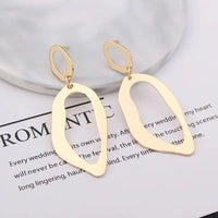 Gold abstract dangle earrings featuring retro charm and statement metal long drop design