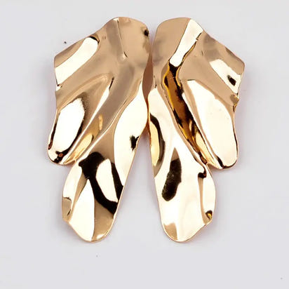 Pair of gold abstract long drop earrings with retro charm in statement metal long design