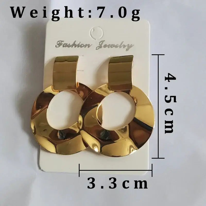 Gold-colored circular drop earrings with retro charm, perfect as statement metal long earrings