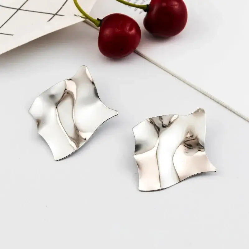 Silver abstract earrings featuring retro charm and long drop design in statement metal long style
