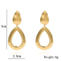 Gold teardrop earrings showcasing retro charm as statement metal long drop earrings
