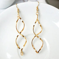 Gold-colored spiral long drop earrings featuring retro charm and statement metal long design