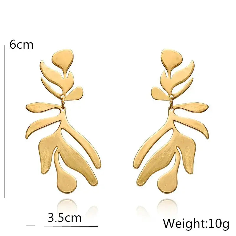 Gold leaf-shaped long drop earrings with retro charm in statement metal long design
