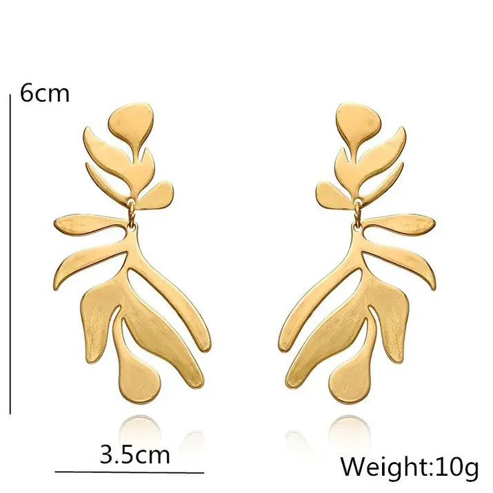 Gold leaf-shaped long drop earrings with retro charm in statement metal long design
