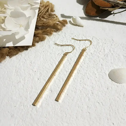 Gold bar earrings featuring retro charm as statement metal long drop earrings