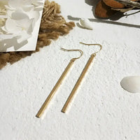 Gold bar earrings featuring retro charm as statement metal long drop earrings