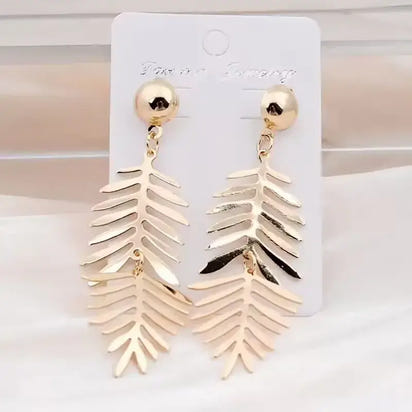 Gold leaf-shaped long drop earrings with retro charm, statement metal long jewelry