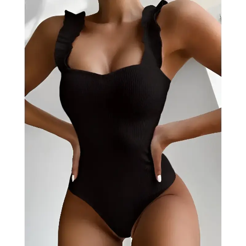 Black ribbed one-piece swimsuit with ruffled straps.
