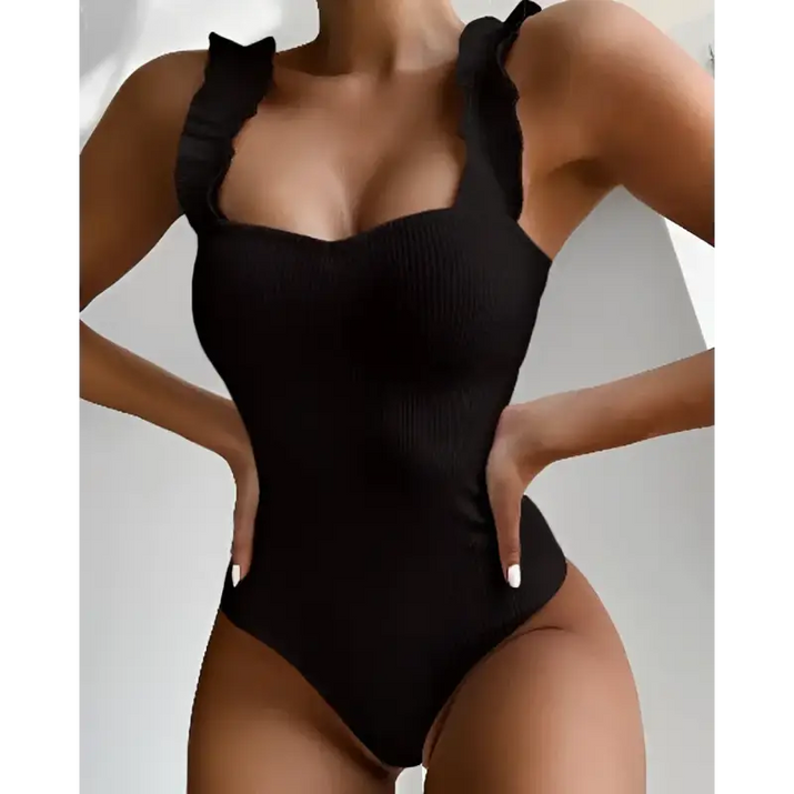 Black ribbed one-piece swimsuit with ruffled straps.