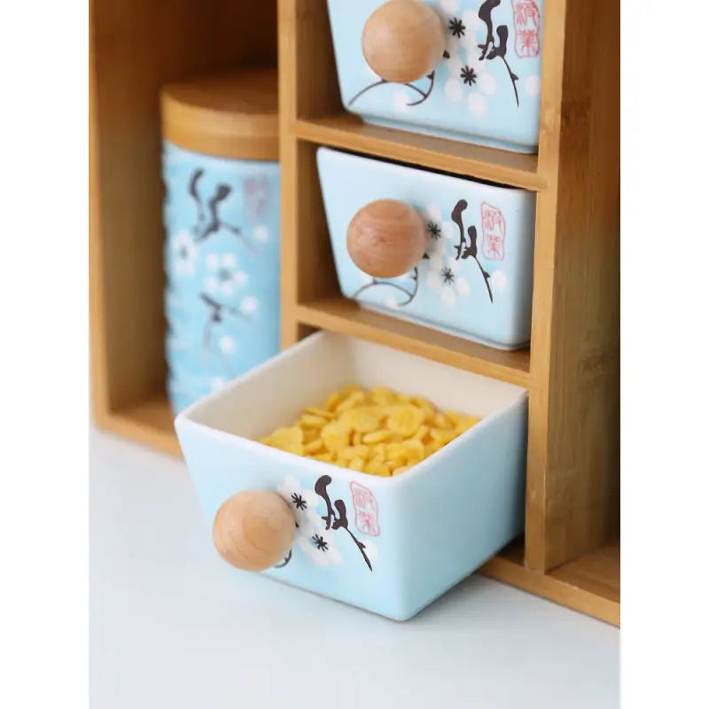 Light blue ceramic drawers with wooden knobs on Salt Sugar Glass Seasoning Box Shelf