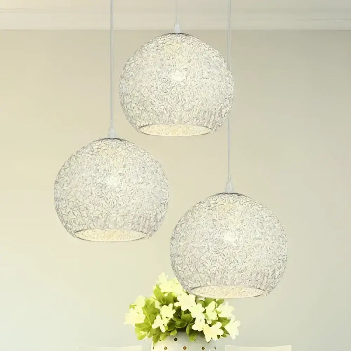 Three spherical, textured pendant lights.