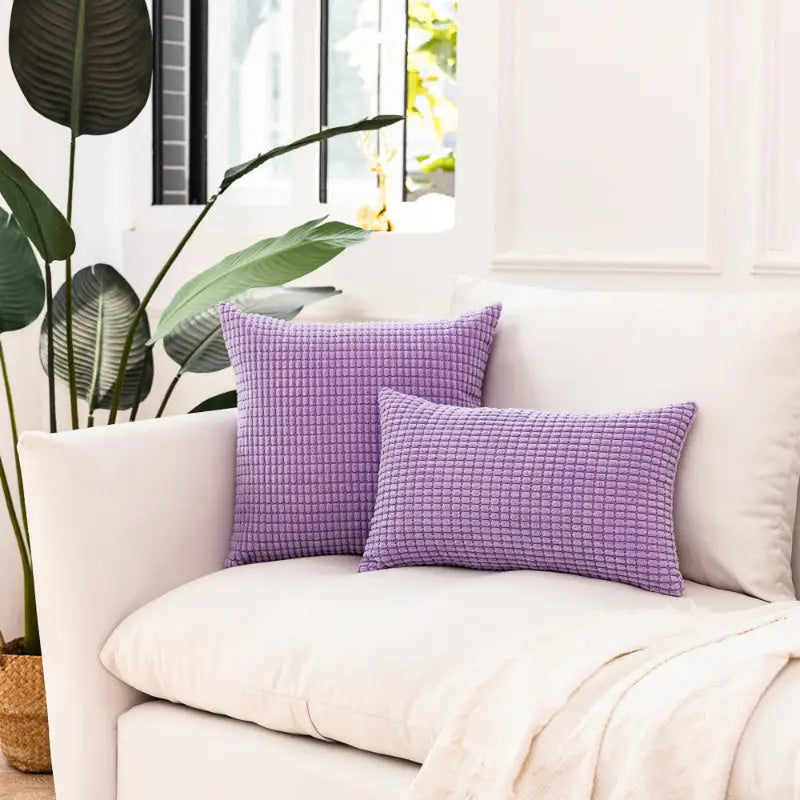 Two textured purple plaid corn kernel kernel square cushion pillows for cozy decor