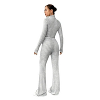 Woman in a striped knit pantsuit.