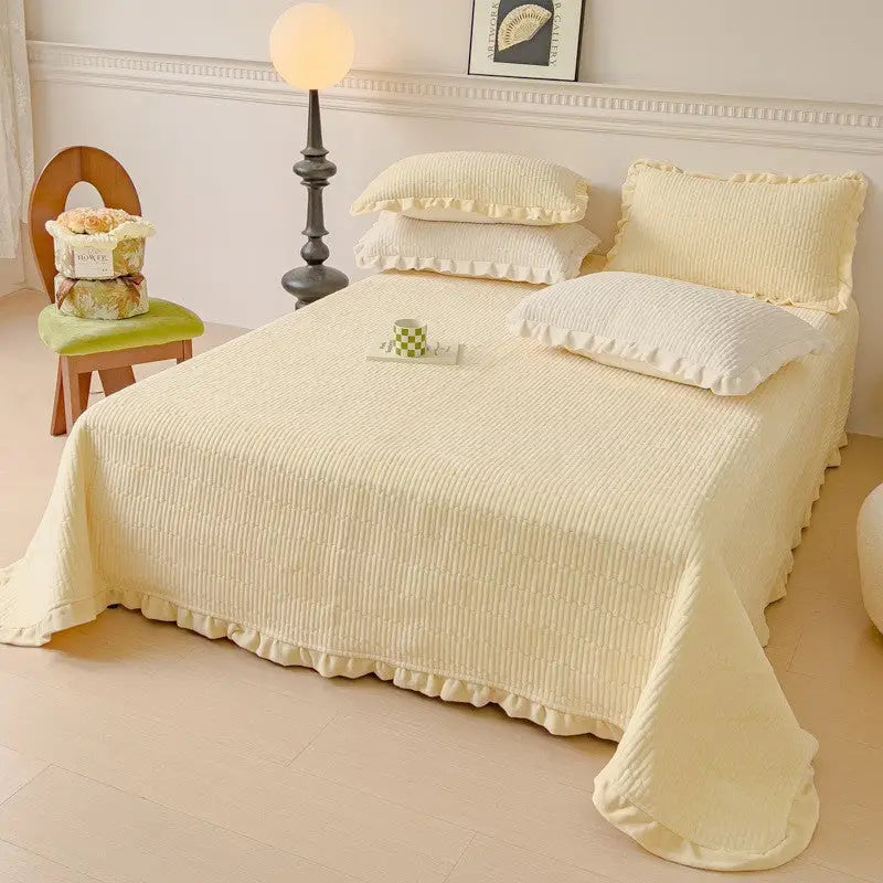 Yellow ruffled bedspread.