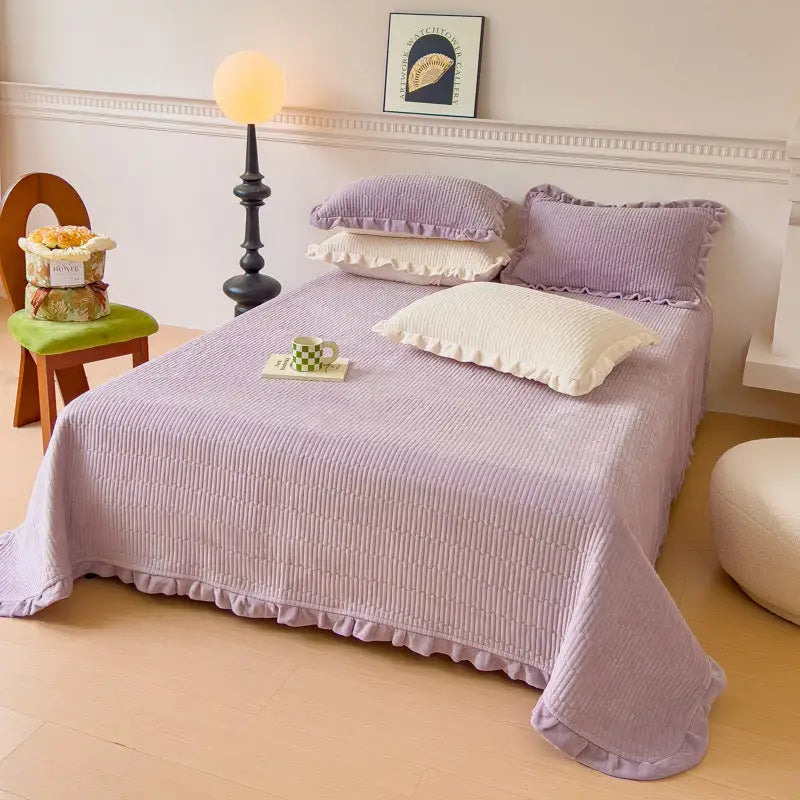 Lavender corduroy bedspread with ruffled edges.