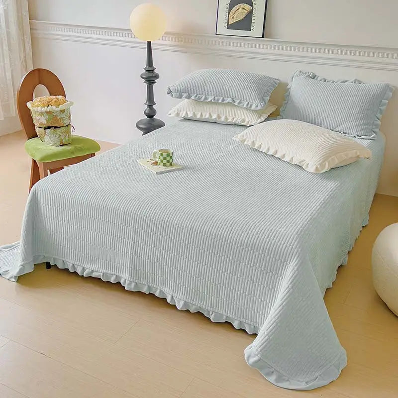 Light blue ruffled bedspread.