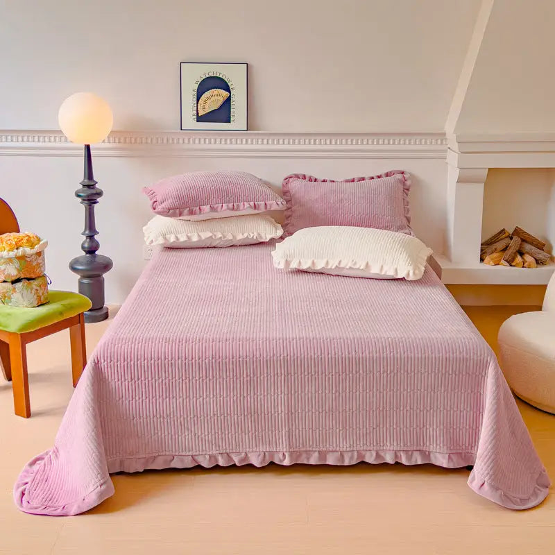 Pink corduroy bedspread with ruffled edges.