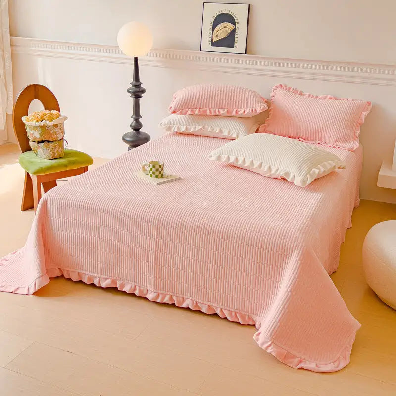 Pink ruffled bedspread.