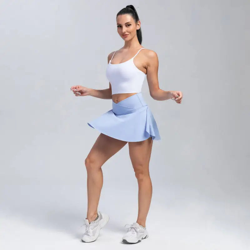 Woman in white top and blue skirt.