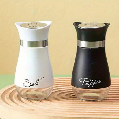 Stainless steel salt and pepper shakers displayed in a Stainless Steel Salt And Pepper Bottle