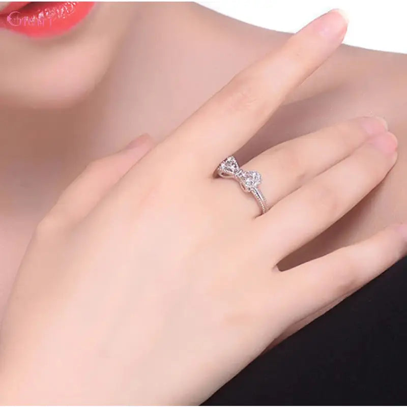 Silver bow-shaped ring.