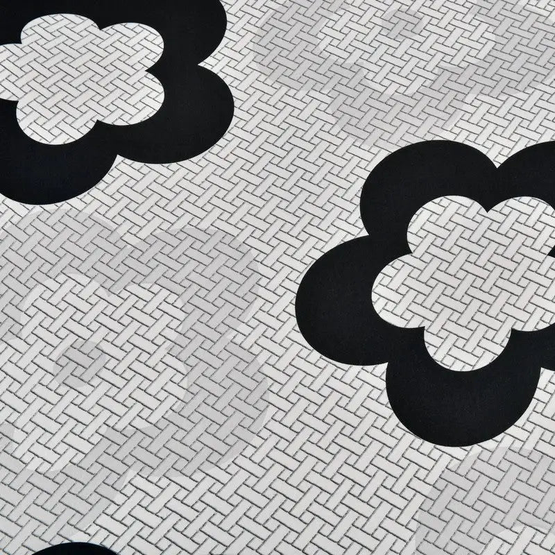 Black floral pattern stretch sofa cover on textured background for stylish sofa protection