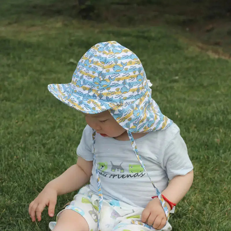 Baby wearing a patterned Summer Sun Cartoon Panama Children’s Hat for child’s summer wardrobe