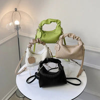 Colorful textured vertical stripe handbag display with pleated designs for stylish accessory