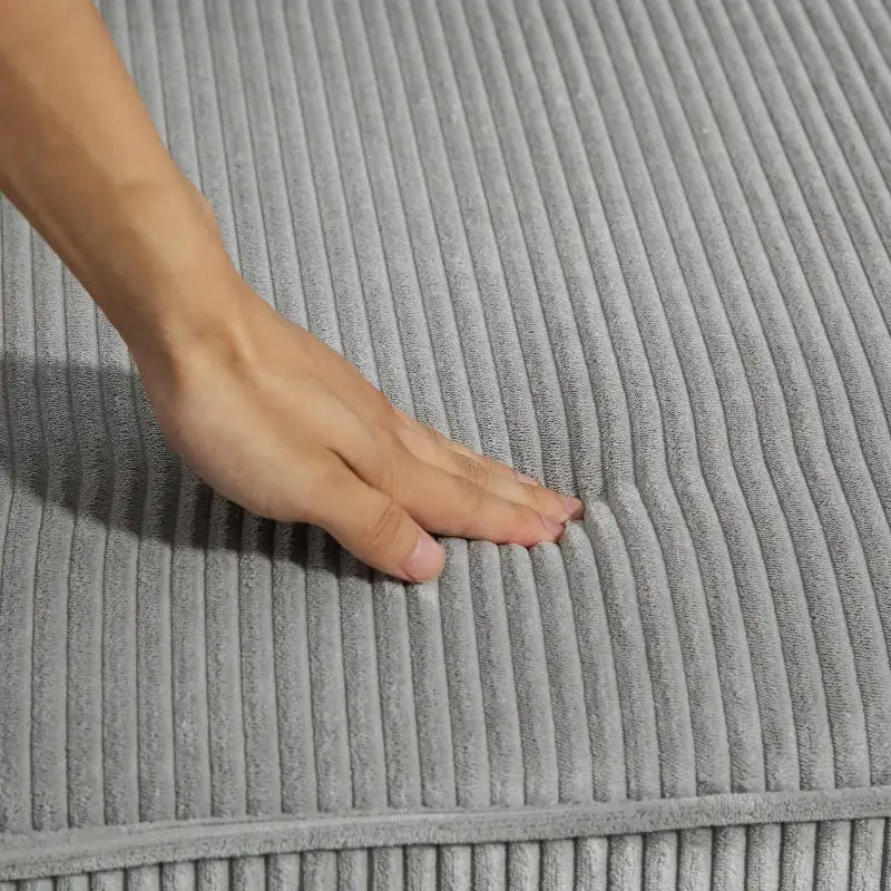 Soft gray corduroy cushion on a three seater sofa for comfortable seating