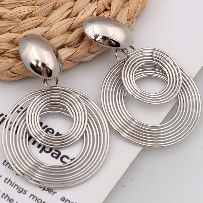 Silver concentric circle earrings showcasing trendy big round statement dangle earrings shape