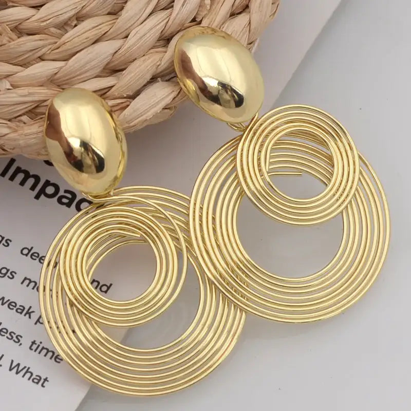 Gold-toned concentric circle statement earrings in trendy big round dangle earrings shape