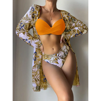 Woman in orange bikini with floral cover-up.