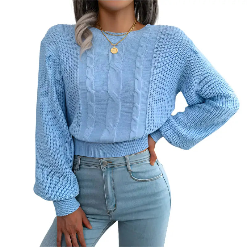 Light blue cable-knit sweater.
