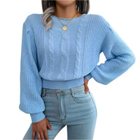 Light blue cable-knit sweater.