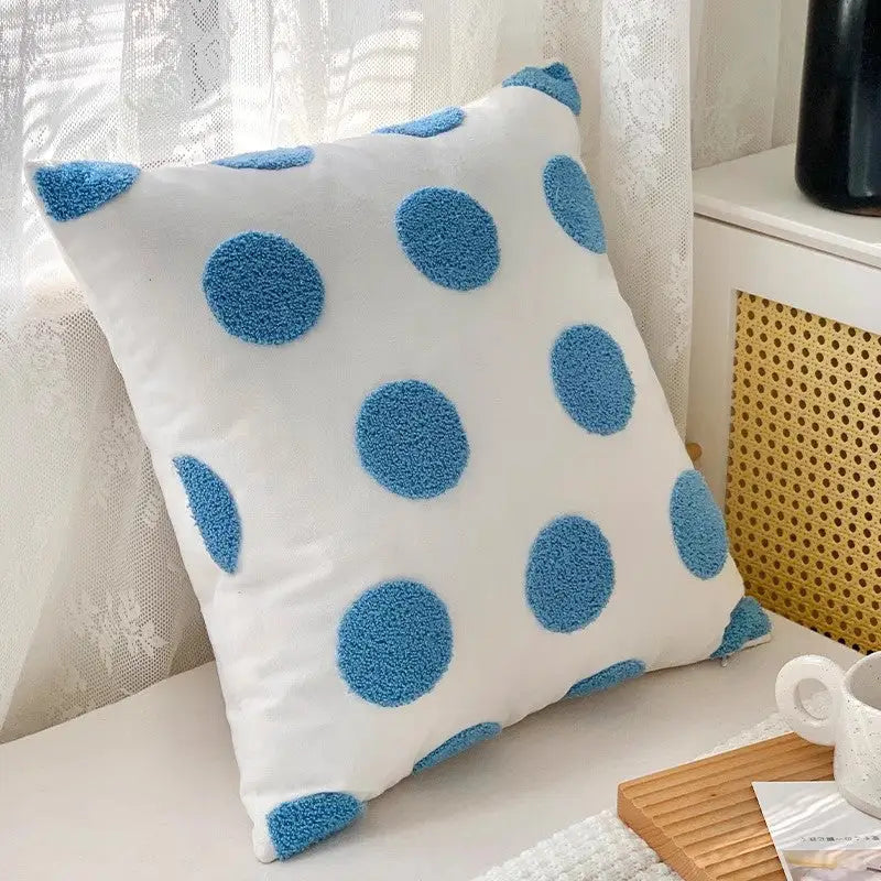 White pillow with blue polka dots on twisted strip sofa throw cushion for cozy decor