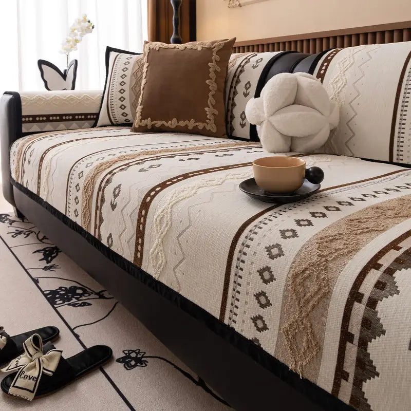 Luxurious cushion cover on patterned sofa with decorative pillows for stylish couch protection