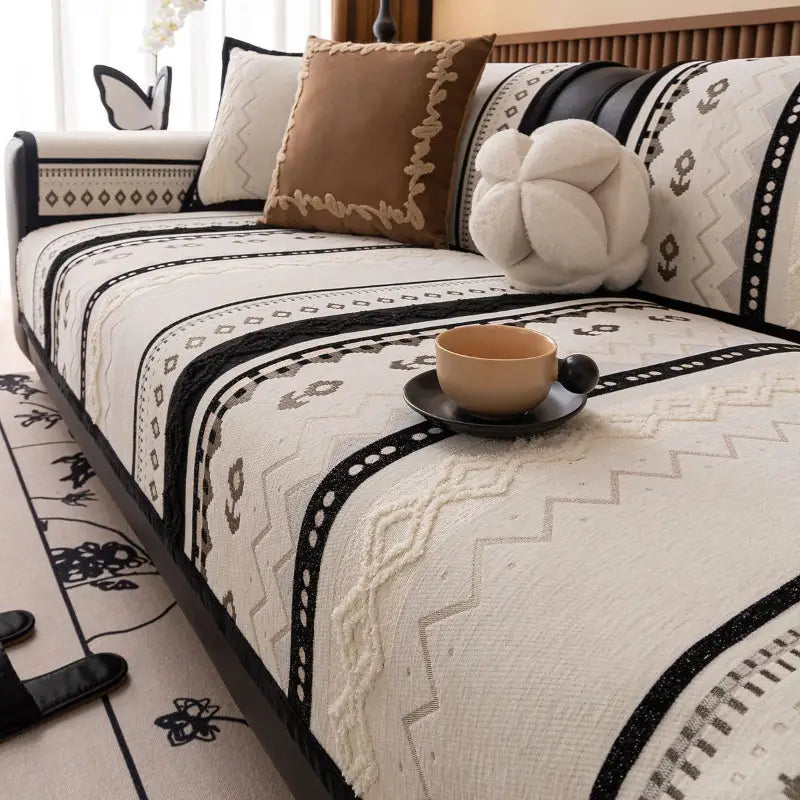 Luxurious cushion cover on patterned couch with decorative pillows for stylish home protection