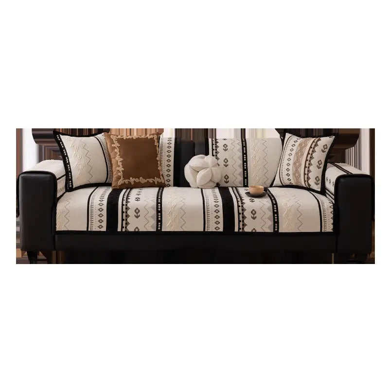 Luxurious cushion cover on black leather sofa with patterned cushions for stylish protection