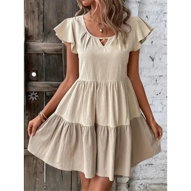 Beige tiered ruffle-sleeve dress.