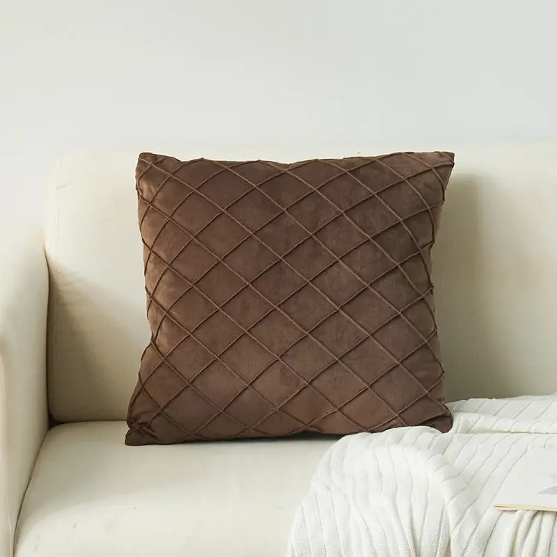 Brown velvet embroidered cozy cushion with diamond-shaped lattice pattern