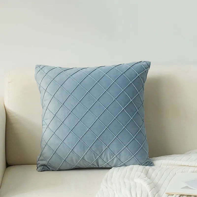 Blue velvet embroidered cushion with diamond-shaped lattice pattern for a cozy look