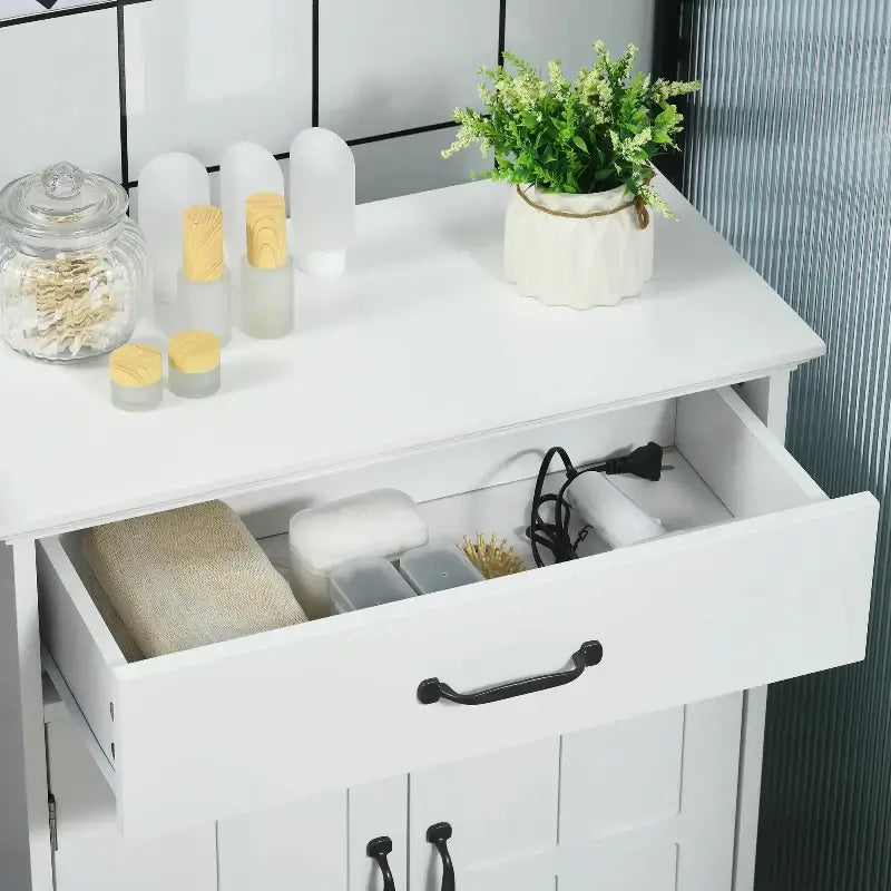 White bathroom cabinet with open drawer.